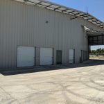 Prefab steel roof with parking overhang at self-storage building
